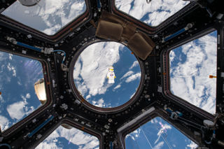 LEGO minifigure floating in the Cupola onboard the ISS