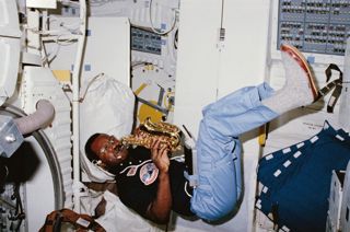 Astronaut Ronald McNair playing his saxophone aboard the Space Shuttle Challenger