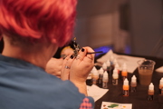 Lady painting a knight at To Boldly Game