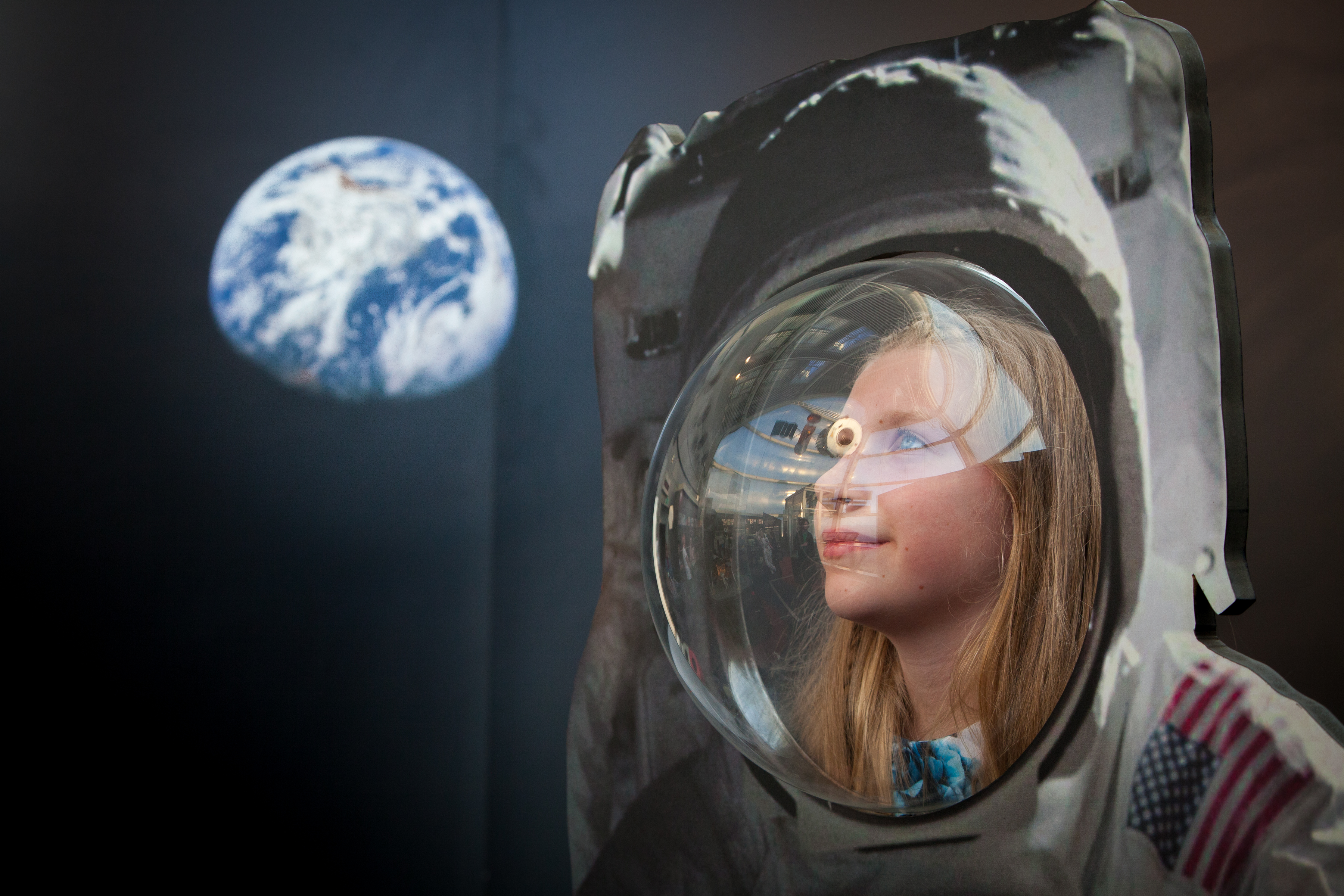 Teen girl in Apollo 11 spacesuit in the Rocket Tower