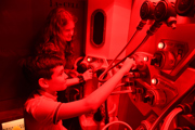 Young girl and young boy participate in a science experiment on Mars 