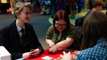 Two young adults enjoying a game and laughing at To Boldly Game