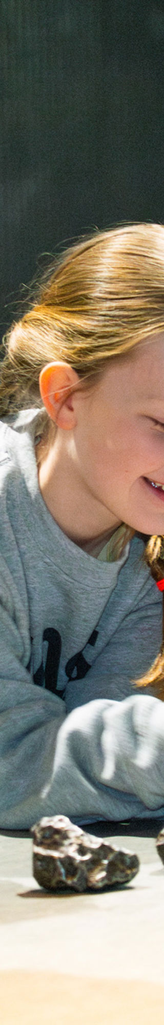 Two children and their parents testing meteorites with magnets