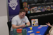 Man laughs whilst playing a game at To Boldly Game