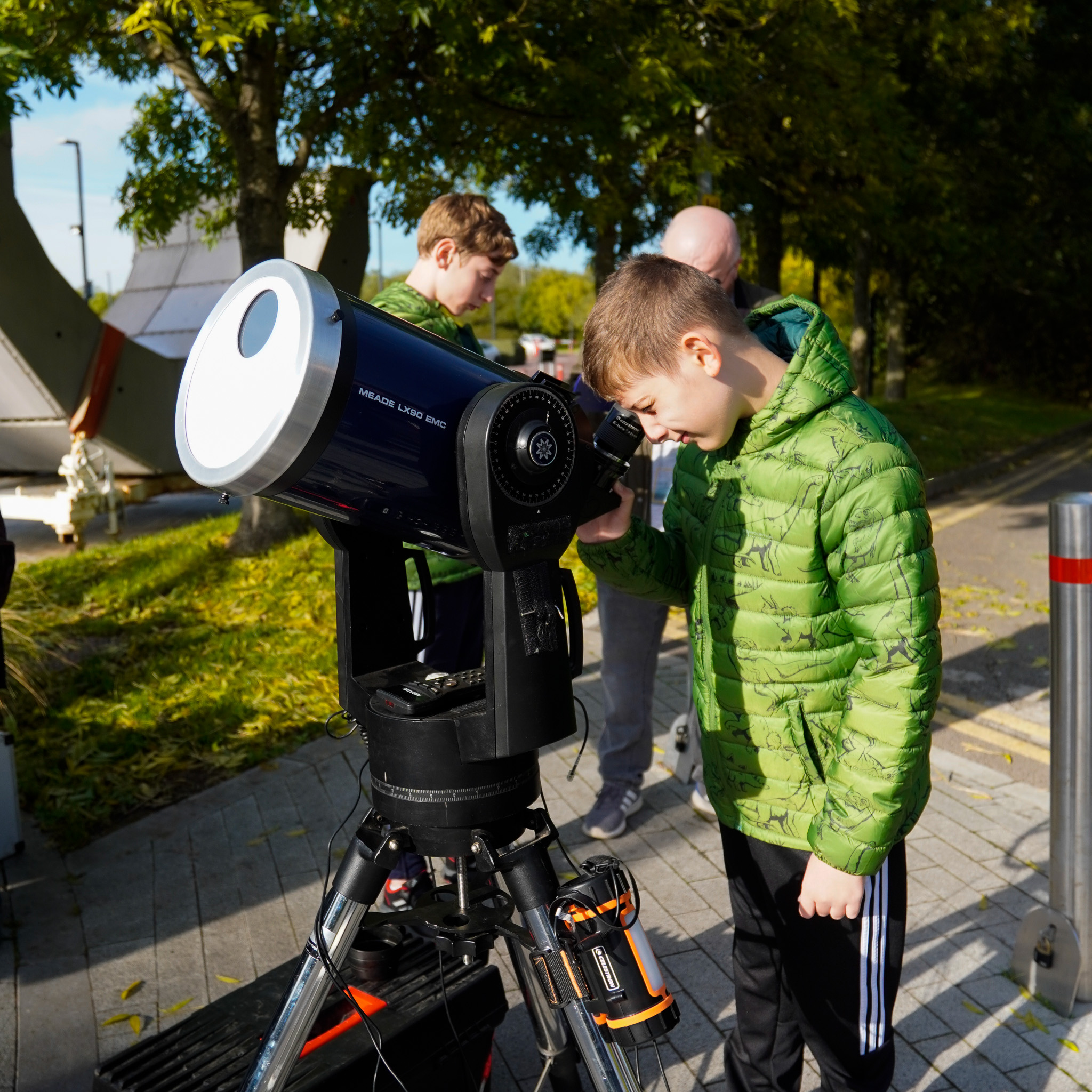 Young boy using a Solar Telescope to watch the solar eclipse safely