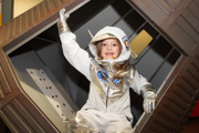 Child in a spacesuit in the Mercury capsule in Into Space