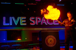 Science Communicator lights a large hydrogen cloud as part of a science talk