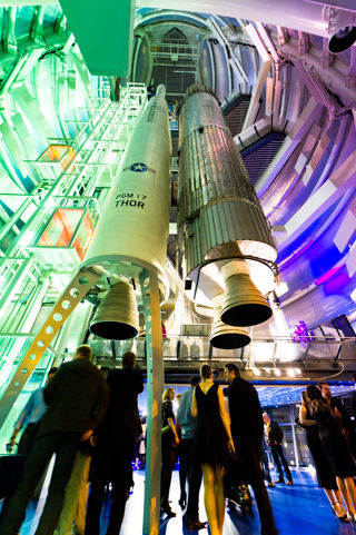 Blue Streak and Thor Able rockets at night with coloured lighting and people