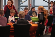 Young girl looks on as family play a game at To Boldly Game