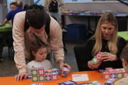 Family play a game with cubes at To Boldly Game