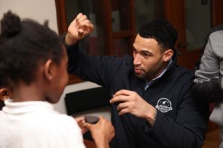 IGNITE Programme manager explaining meteorites to a child 