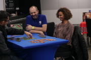 Imagination Games demo team help a couple of players at To Boldly Game