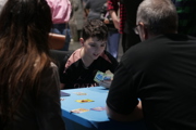 Young boy and family enjoy a card game at To Boldly Game