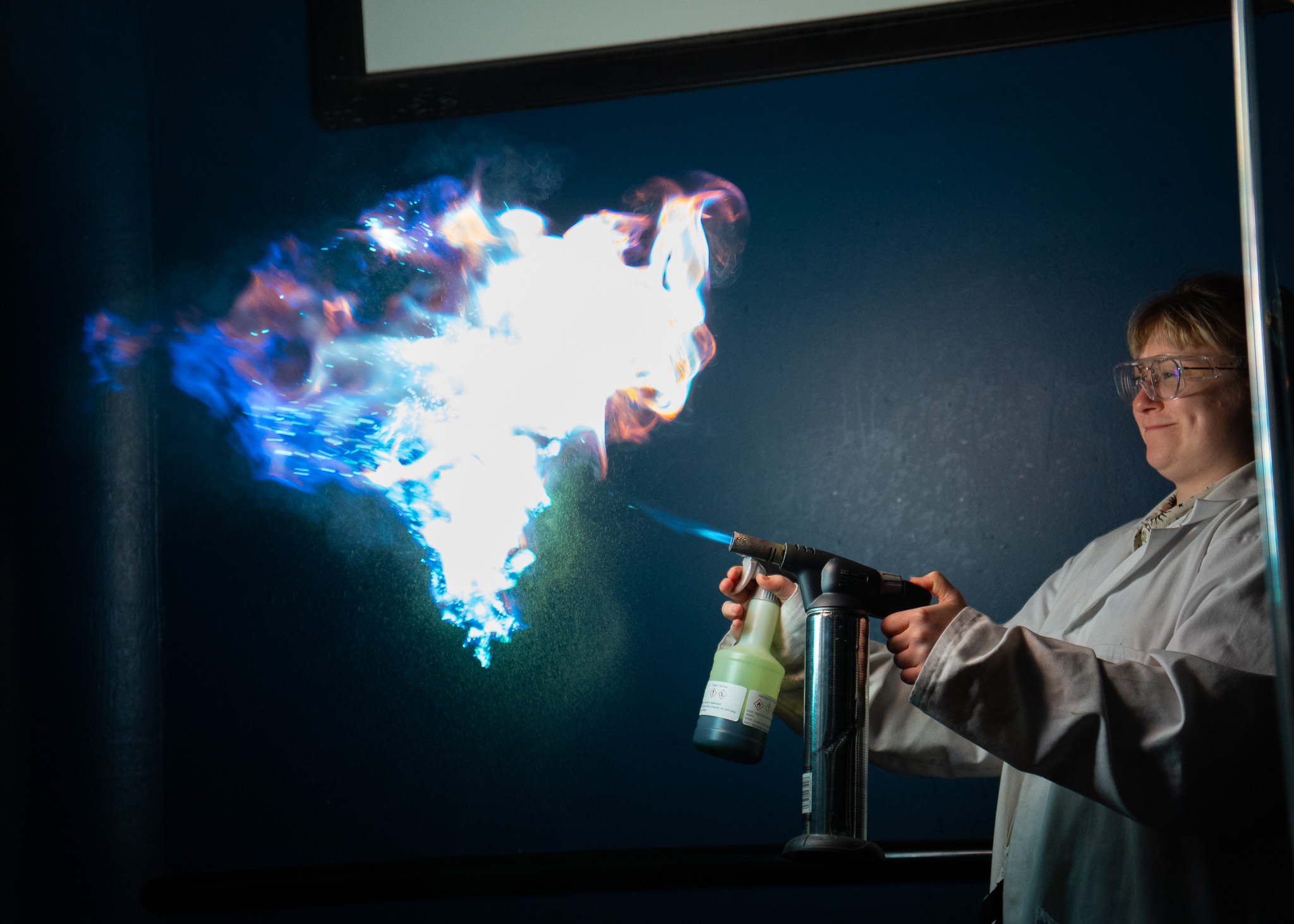 Science communicator with fire on the LIVE Space stage at the UK in Space festival