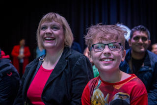 Mother and son laugh at a science talk in LIVE Space 
