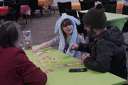 Girl with a long eared hat plays a game at To Boldly Game