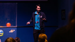 Science Communicator giving a talk on the LIVE Space stage