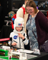 Mother and child in a spacesuit looking at a LEGO airport