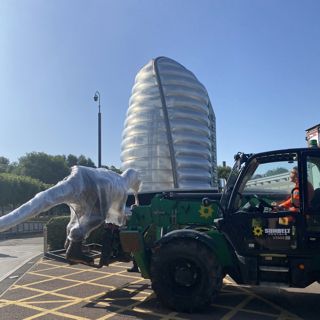 Dinosaur Being Loaded Into National Space Centre on Forklift