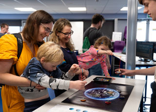 Child and mother in the science lab at the UK In Space Festival