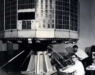 Tiny scientist looks up in wonder at their creation