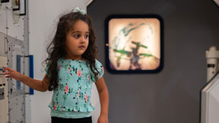 Young girl in the Columbus Module at Small Space Day