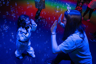 Happy child and mother with bubbles at Sensory play at Small Space Day