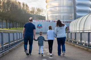 Family arriving at the Centre walking down the ramp
