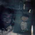 Astronaut John Young holding a drawing of Charlie Brown onboard Apollo 10.