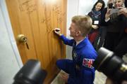 Tim Peake Performs The Traditional Door Signing At The Cosmonaut Hotel