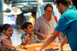 Family enjoying a science busk demonstration 