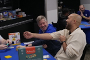 Group of men laugh whilst playing a game at To Boldly Game