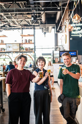 Eilish, Kat and Isaac raising a glass of Citrus Supernova beer at Everards