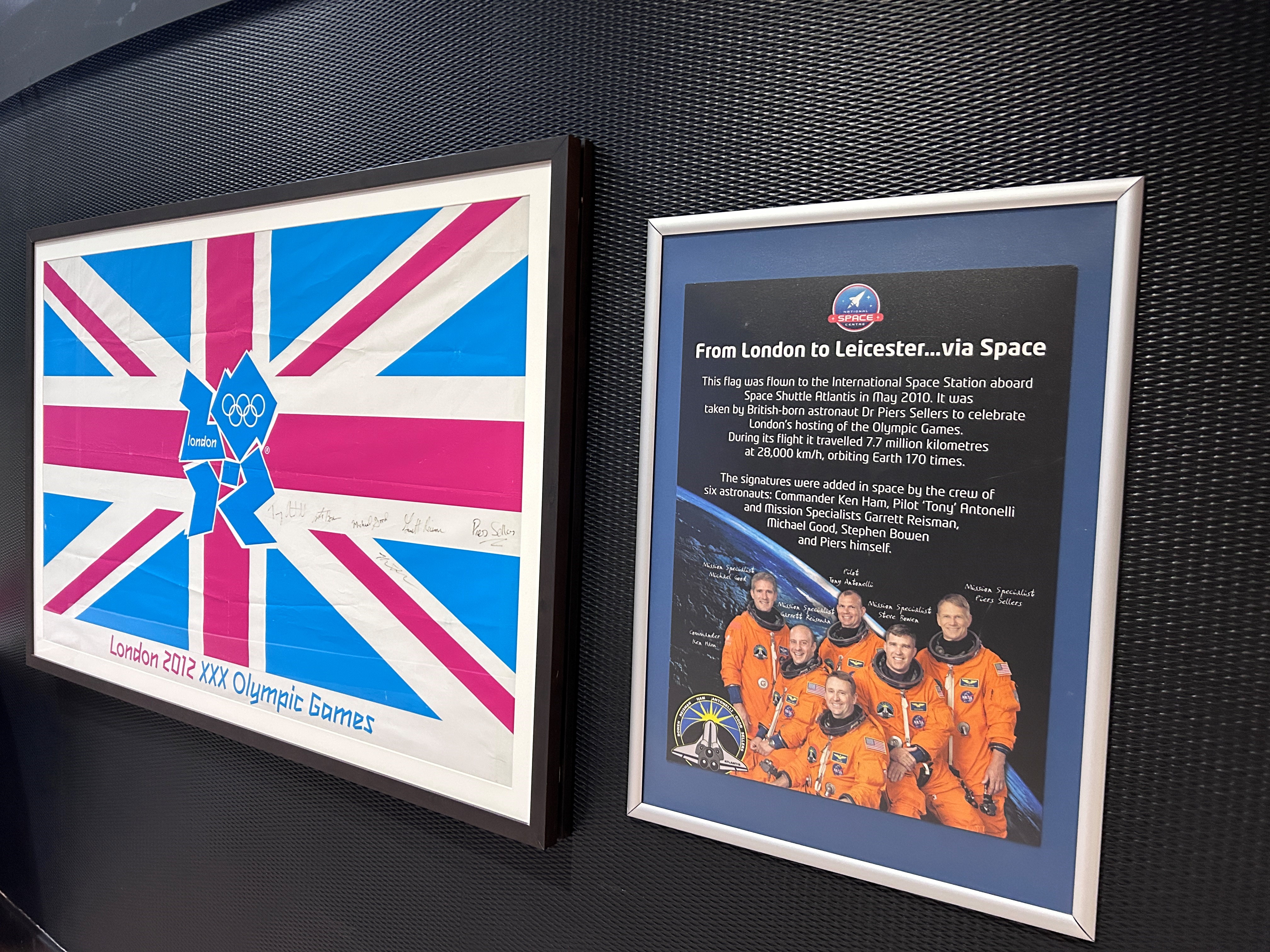The 2012 Olympic flag signed by astronauts on display outside the Planetarium.