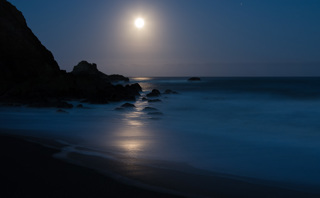 A full moon setting over the pacific. 