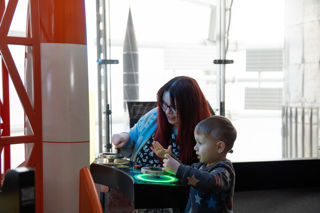 Young child and mother in the Britain's Space Race exhibition at Small Space Day