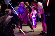 Young child being helped in the Lightsaber class at Galactic Gathering