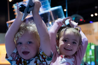 Two small children in Home Planet at Small Space Day