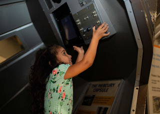 Child launching the Mercury 7 capsule