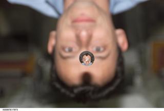 Aboard the International Space Station (ISS), European Space Agency astronaut Pedro Duque of Spain watches a water bubble float between a camera and himself. The bubble shows his reflection (reversed)